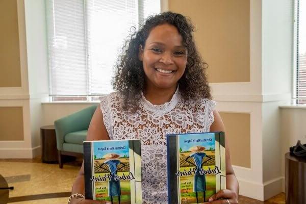 Shenandoah University Assistant Professor of English Christin Taylor, Ph.D., with her book "Labor Pains."